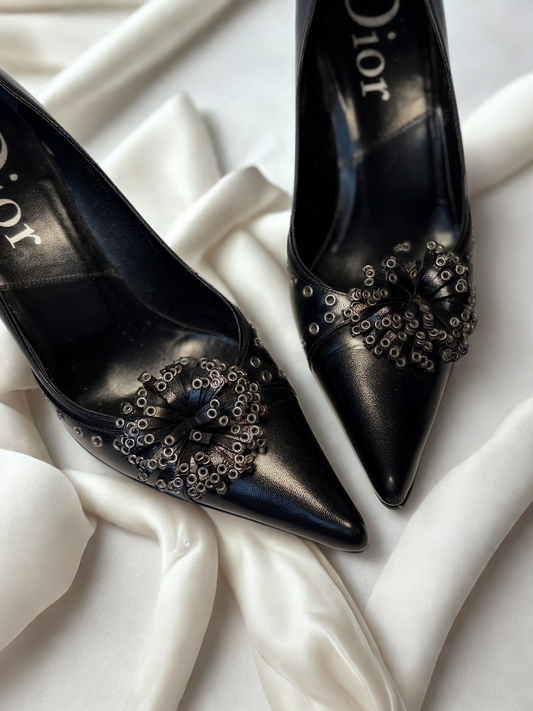 Close-up of Dior studded embellishments on pointed toe pumps